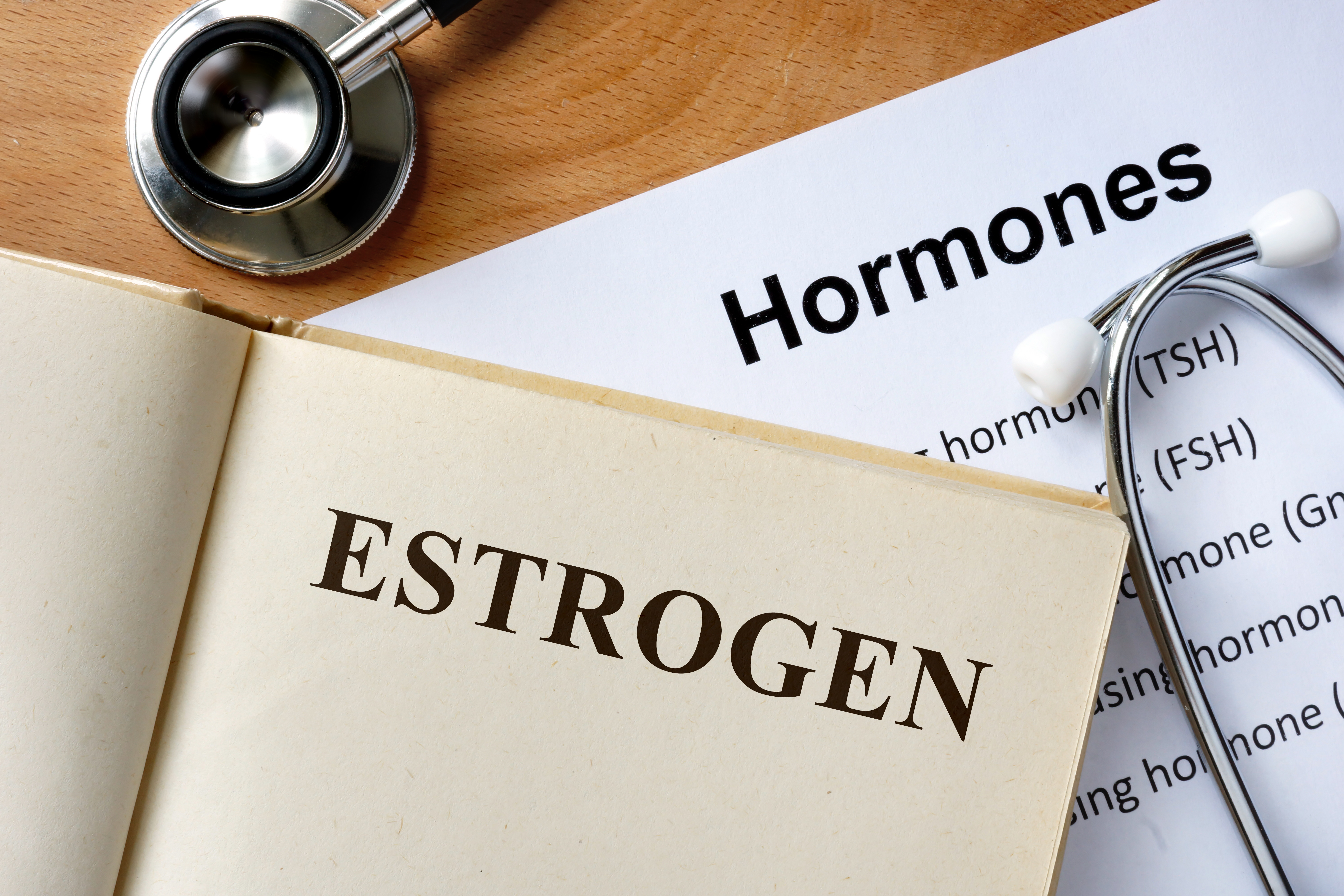 Estrogen word written on the book and hormones list.